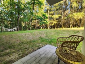 a table and chairs sitting on a patio with a field at Apartament Podedworze in Bochnia