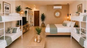 a bedroom with two bunk beds and a room with at Nora's Place in Panglao Island