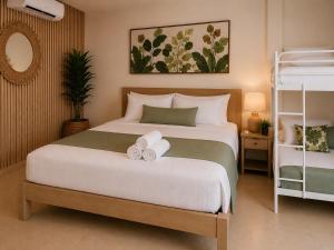a bedroom with a large white bed with bows on it at Nora's Place in Panglao Island