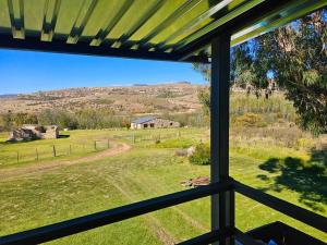 a view of a field from a window at Clarossouw in Clarens