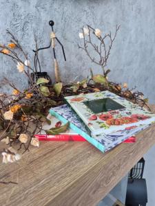 a book sitting on top of a table with flowers at Balkan tower REST 2 Безплатно паркомясто in Gabrovo
