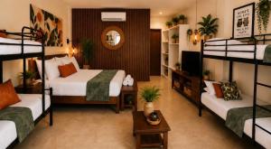 a bedroom with two beds and a living room at Nora's Place in Panglao Island