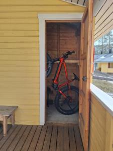 a bike sitting inside of a wooden house at Polar Star Apartments in Levi