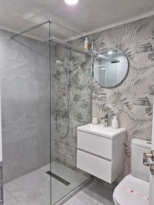 a bathroom with a shower and a sink and a mirror at Balkan tower REST 2 Безплатно паркомясто in Gabrovo +17 photos