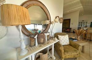 a table with a mirror and a chair and a lamp at Kangela 1 in Ponta Malangane +23 photos
