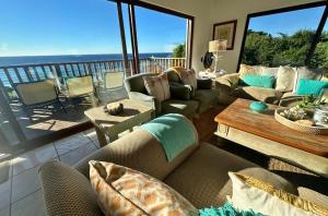a living room with couches and a view of the ocean at Kangela 1 in Ponta Malangane