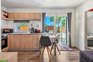 a kitchen with a table and a dining room with a view at Tinyhaus Sankt Rupert Nummer 11 in Riedenburg