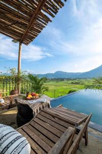 a patio with a table and a view of the water at Mây Villa HA in Yên Bài