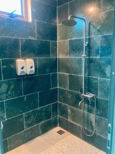 a bathroom with a shower with blue tiles at Mây Villa HA in Yên Bài +46 photos