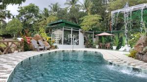 a swimming pool in the middle of a house at GIARDINO ROMANTICO in Dumaguete