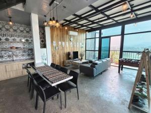 a living room with a couch and a table and chairs at Mây Villa HA in Yên Bài