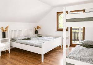 a bedroom with two bunk beds and a window at HOSTEL VANEČA in Puconci