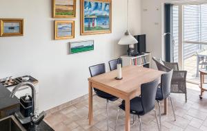 a dining room with a wooden table and chairs at 2 Bedroom Nice Apartment In Samsø in Ballen