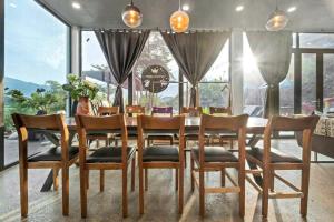 a dining room with a long table and chairs at Nang Villa HA in Yên Bài