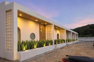 a row of buildings with plants on the side at Meena boutique in Ban Nai Wat +14 photos