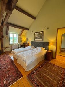 a bedroom with a large bed and a rug at Villa Emma in Mavilly-Mandelot +44 photos
