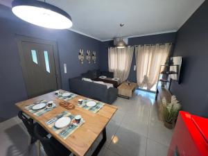 a living room with a table and a couch at Elafonisi Paradise with Parking, WiFi, - Walking Distance to the Beach in Elafonisi