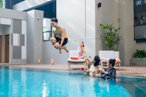a group of people sitting in a swimming pool at Harris Hotel & Convention Serpong in Tangerang +18 photos