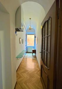 a hallway with a door and a room with a table at La Dolce Vita in Pisa +2 photos