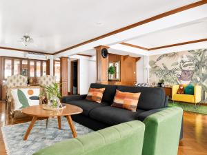 a living room with a couch and a table at Pannarai's House in Bangkok