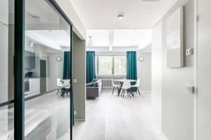 a kitchen and living room with a table and chairs at Spot Apartments Hyrylä in Hyrylä