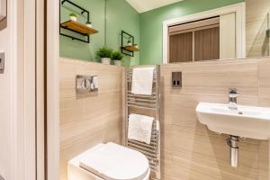 a bathroom with a sink and a toilet at York Cocoa Suites - city centre apartments in York +36 photos