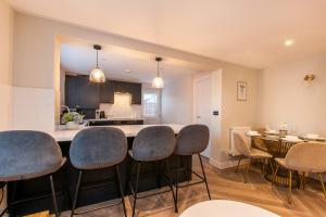 a kitchen and dining room with a table and chairs at Marsh House - Modern Apartment With Hot Tub in Whitstable