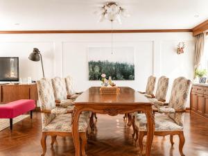a dining room with a wooden table and chairs at Pannarai's House in Bangkok +27 photos