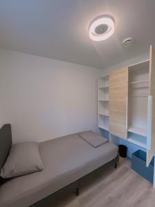 a bedroom with a bed and a light on the ceiling at Claire House in Vancouver