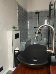 a bathroom with a black sink and a shower at Palacete da Vermelha in Vermelho +14 photos