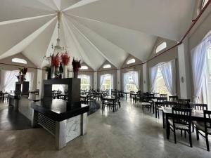 a dining room with tables and chairs and windows at Çamyuva Luna Hotel in Kemer +60 photos