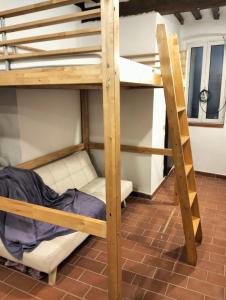 a bunk bed in a room with a ladder at Outside the Townhall in Piombino