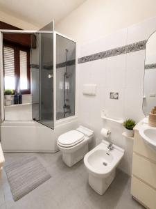 a bathroom with a toilet and a shower and a sink at Harbor Elegance Estate in Milazzo +25 photos