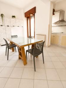 a kitchen with a wooden table and chairs in a room at Harbor Elegance Estate in Milazzo