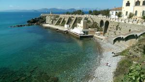 an aerial view of a beach next to the water at Outside the Townhall in Piombino