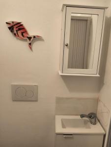 a bathroom with a sink and a mirror at Outside the Townhall in Piombino