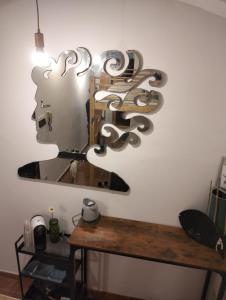 a mirror on a wall next to a wooden table at Outside the Townhall in Piombino +12 photos
