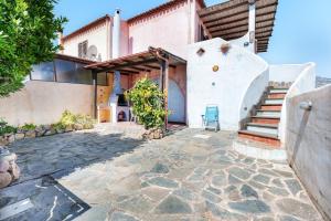 an exterior view of a house with a stone patio at Orosei Domo in Orosei