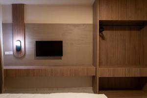a room with a tv on a wall at Dremka Guesthouse Peshtani in Ohrid +41 photos