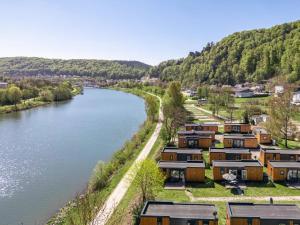 a row of homes next to a river at Tinyhaus Sankt Rupert Nummer 11 in Riedenburg