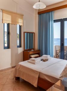 a bedroom with a bed with towels on it at Royal Bay Villa Bali in Bali