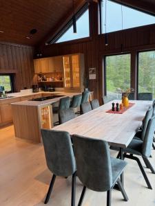 a large wooden table and chairs in a kitchen at Stor hytte på Gaustablikk in Gaustablikk
