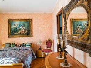 a bedroom with a bed and a table with a mirror at Villa Di Marmo in Trappitello +19 photos