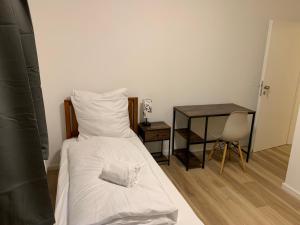 a small bedroom with a bed and a table at Apartments Adelheid in Wathlingen