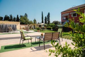 a group of chairs and a table in a yard at Villa Vasiliki in Lefkimmi