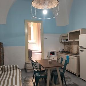 a kitchen with a table and chairs in a room at Piazza Verdi Liberty House in Lecce