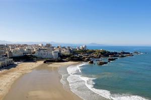 an aerial view of a beach with buildings and the ocean at EHDΞN Biarritz Arbonne in Arbonne