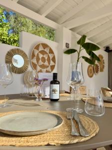 a table with glasses and a bottle of wine on it at Vida Lenta Boutique Finca in Alora