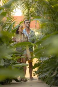 Ein Mann und eine Frau stehen im Dschungel in der Unterkunft Lio Lio Suites Private Pools in El Nido