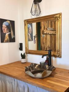 a bathroom with a sink and a mirror at Rozkoszne Roztocze - domek na wynajem in Staw Noakowski +51 photos